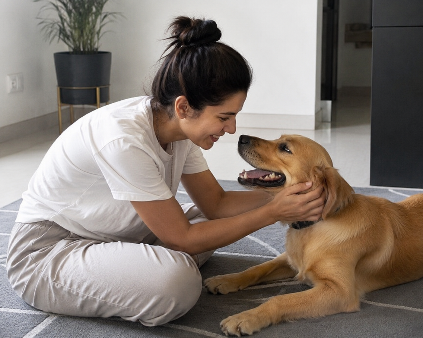 ChatGPT free AI image generator result, woman in white t-shirt sitting cross-legged on a grey geometric rug, holding a golden retriever's face while the dog looks up at her, modern minimal home setting